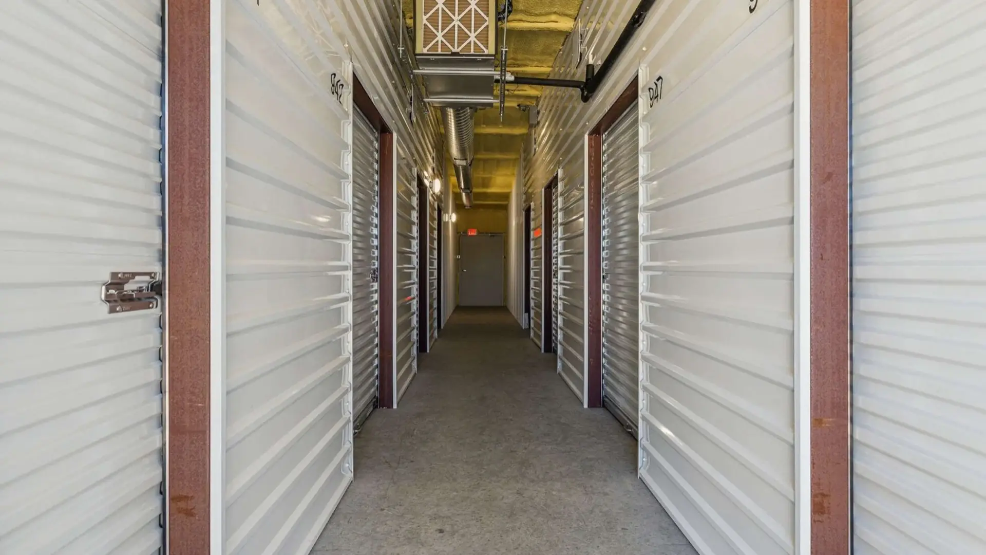 Wide drive aisle between drive-up storage units on Western Hills Trail