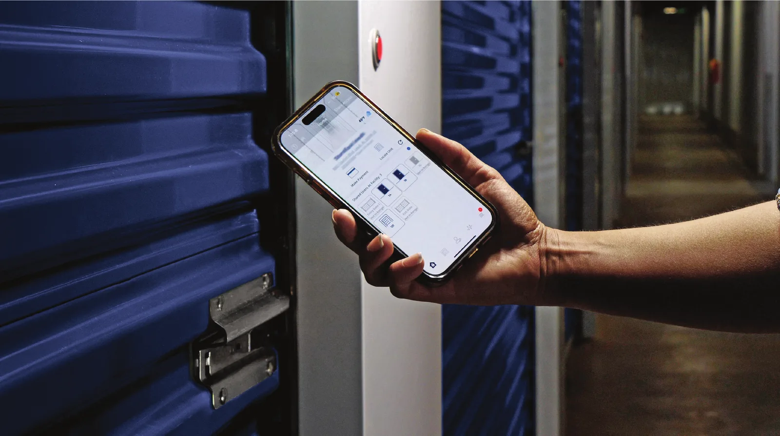 A phone held beside the electronic latch on a roll-up door