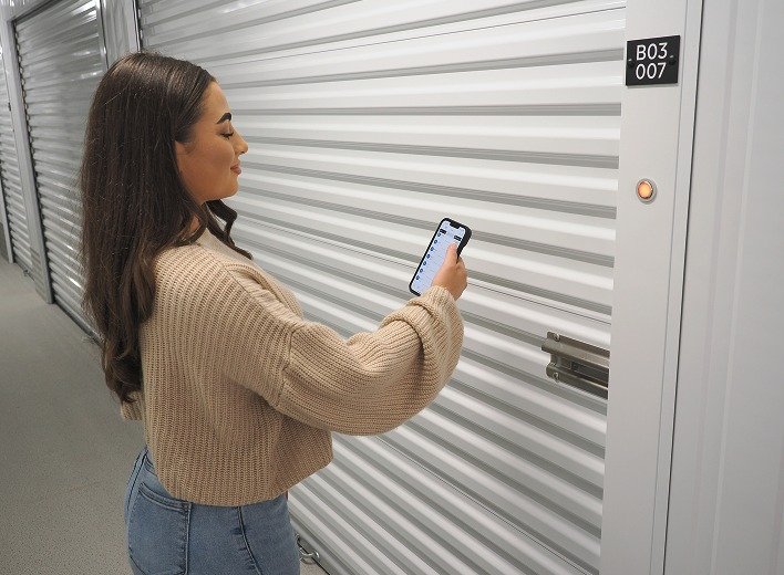 A tenant opening the app as she walks up
